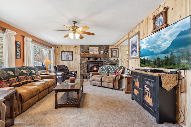 living room with light carpet, wooden walls, and ceiling fan