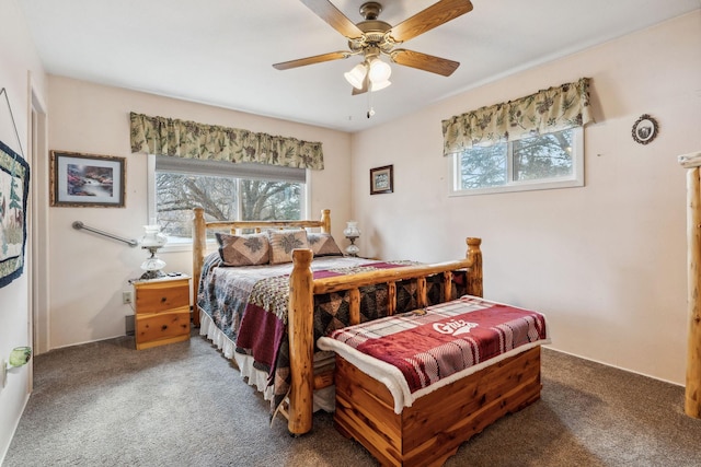 bedroom with a ceiling fan, multiple windows, and carpet flooring