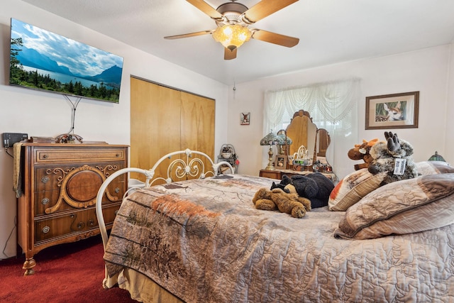 bedroom with a ceiling fan and carpet