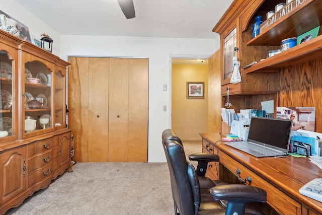 office space featuring light carpet and a ceiling fan