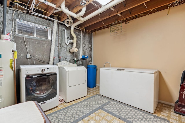 laundry room with separate washer and dryer, tile patterned floors, laundry area, and water heater