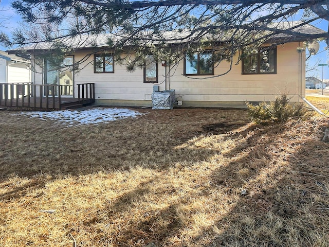 back of property featuring a wooden deck