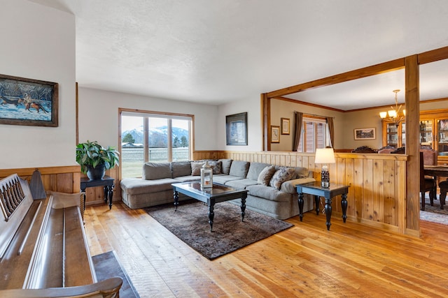 297 Christofferson Ln, Corvallis, MT 59828 - living area featuring hardwood / wood-style flooring, a wainscoted wall, a chandelier, and wood walls