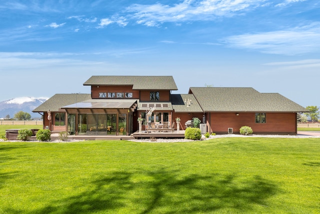 297 Christofferson Ln, Corvallis, MT 59828 - rear view of house featuring a wooden deck, a lawn, and a shingled roof