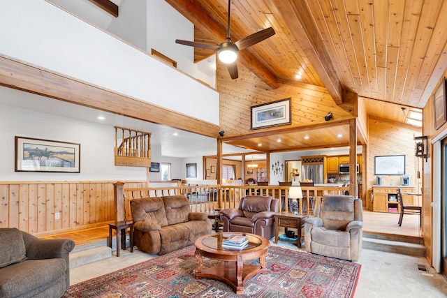 297 Christofferson Ln, Corvallis, MT 59828 - living room with wood walls, a ceiling fan, beam ceiling, a towering ceiling, and wood ceiling
