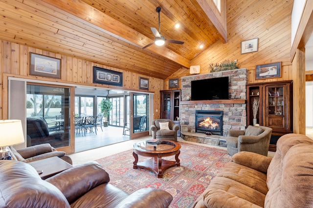 297 Christofferson Ln, Corvallis, MT 59828 - living area featuring wood walls, high vaulted ceiling, a stone fireplace, a ceiling fan, and beamed ceiling