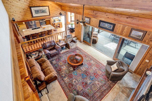 297 Christofferson Ln, Corvallis, MT 59828 - living room featuring wooden walls, carpet, and ceiling fan