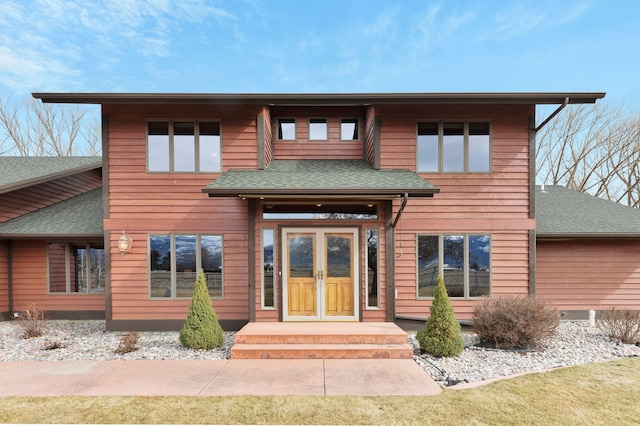 prairie-style home featuring a shingled roof