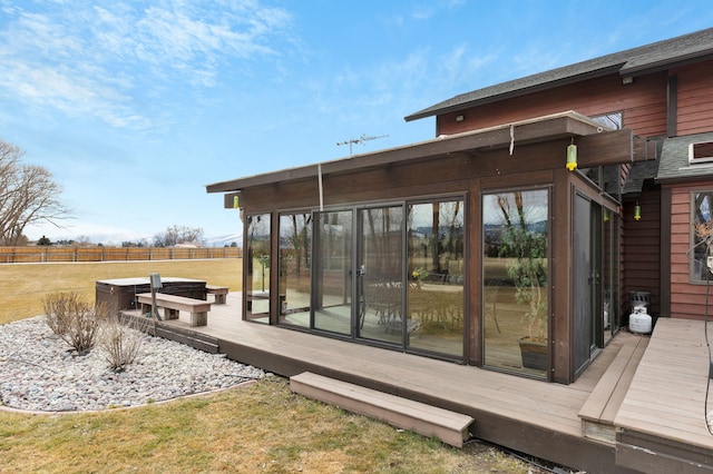 wooden deck featuring fence and a sunroom