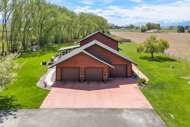 297 Christofferson Ln, Corvallis, MT 59828 - garage featuring a rural view, concrete driveway, and a mountain view