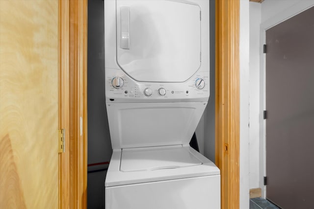 laundry area with laundry area and stacked washer / dryer