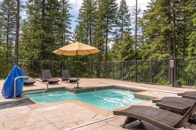 view of swimming pool featuring a patio area, fence, and a swimming pool