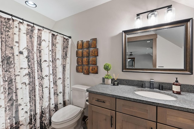 full bath featuring a shower with shower curtain, vanity, and toilet