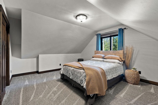 bedroom with carpet, vaulted ceiling, and baseboards