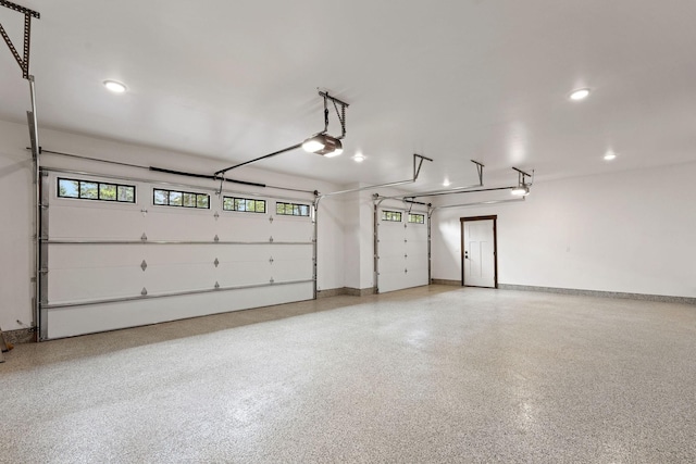 garage featuring recessed lighting, baseboards, and a garage door opener