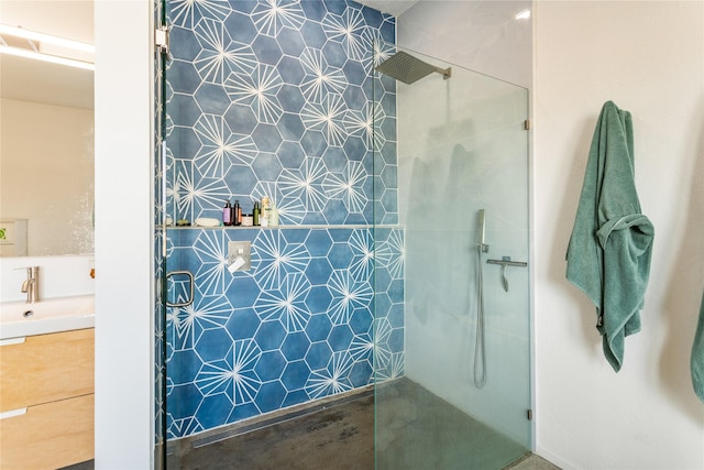 bathroom featuring a tile shower and vanity