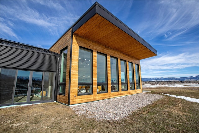 view of side of home with a mountain view