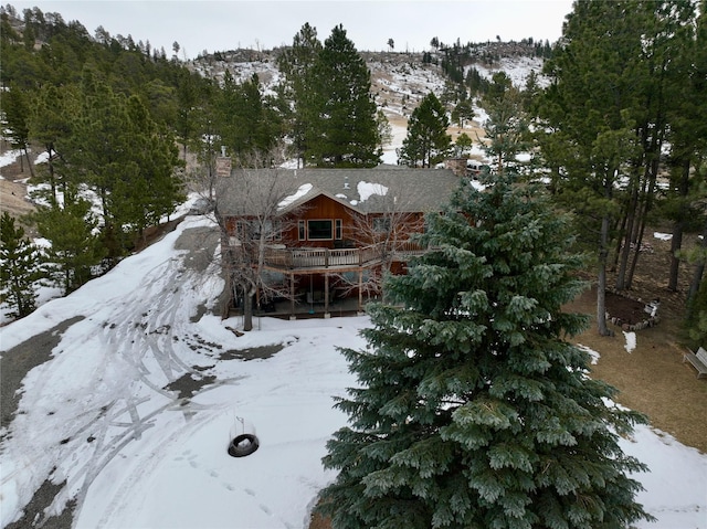 3465 Pine Hills Dr, Helena, MT 59602 - snow covered house featuring a chimney and a wooden deck