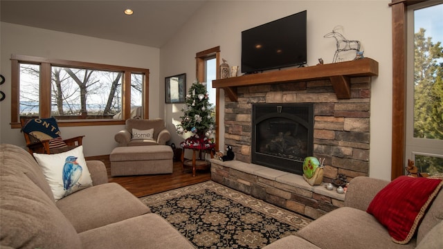 living room featuring lofted ceiling, a fireplace, recessed lighting, and wood finished floors