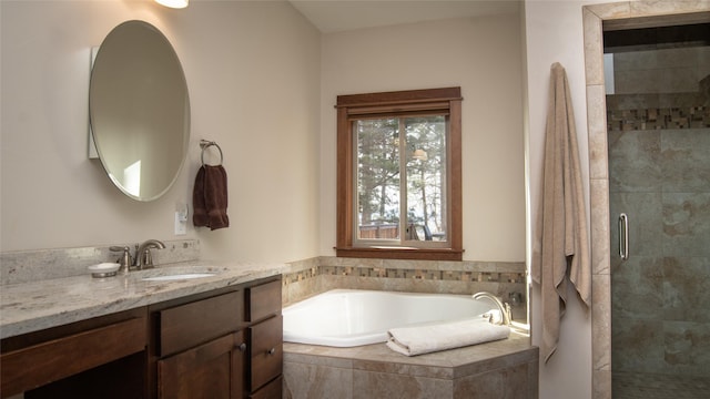 full bathroom featuring a garden tub, a tile shower, and vanity