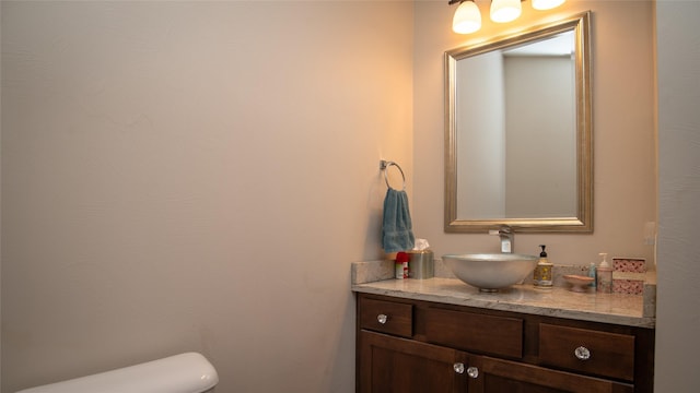 bathroom with toilet and vanity