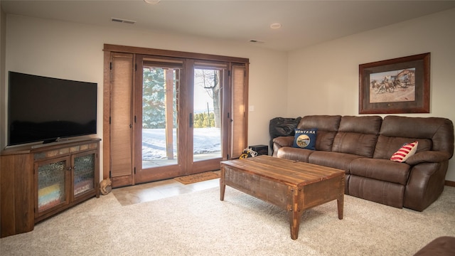 carpeted living room featuring tile patterned flooring and visible vents