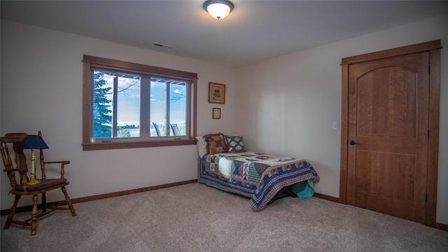 bedroom with carpet floors, visible vents, and baseboards