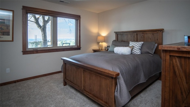 bedroom featuring light carpet, visible vents, and baseboards