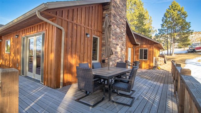 wooden deck with outdoor dining area and french doors