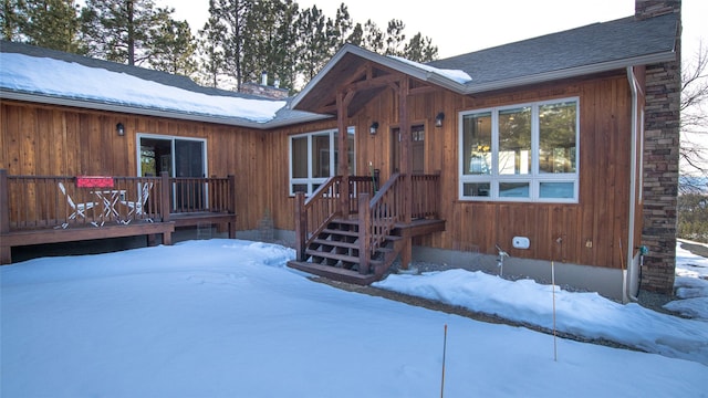 exterior space featuring a shingled roof and a chimney