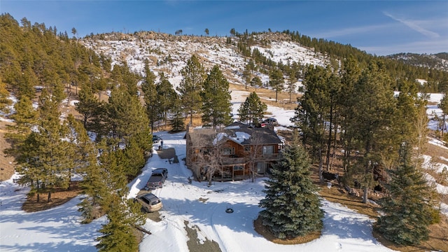 snowy aerial view featuring a mountain view