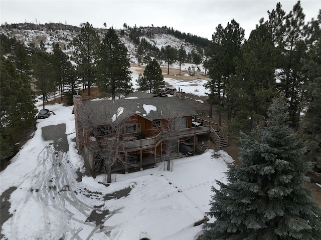 snowy aerial view with a mountain view