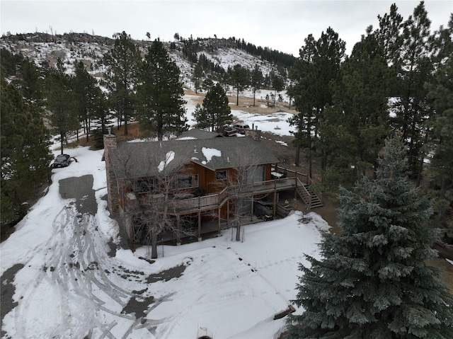 snowy aerial view featuring a mountain view