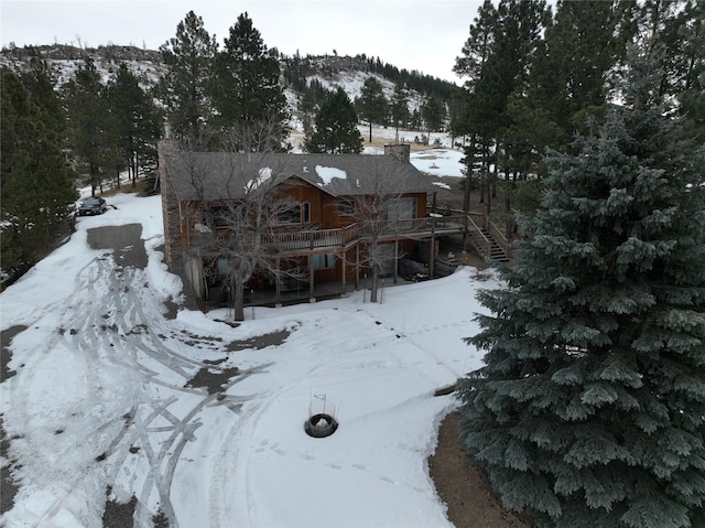 exterior space with stairs and a deck with mountain view