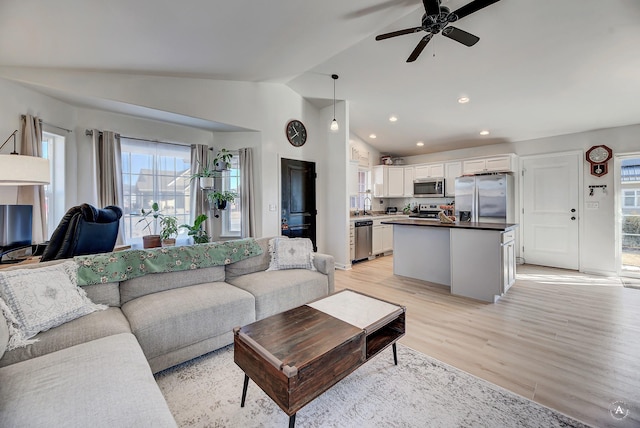 living room featuring vaulted ceiling, recessed lighting, a ceiling fan, and light wood-style floors