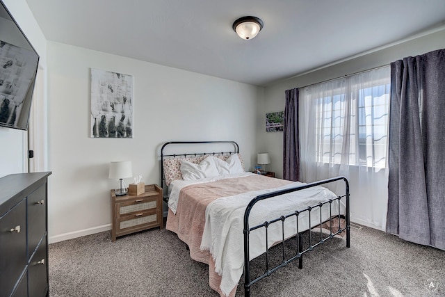 bedroom featuring carpet flooring and baseboards