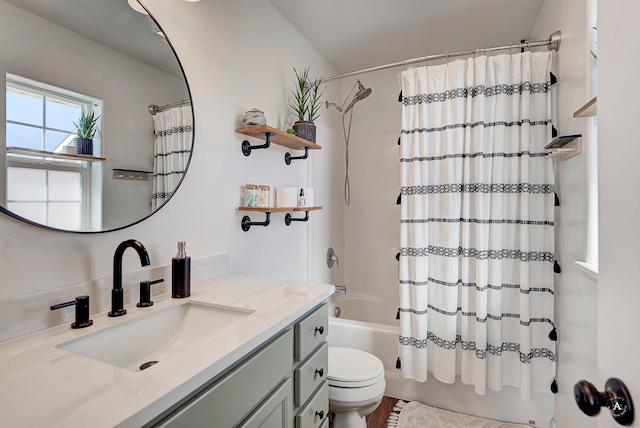 full bathroom featuring toilet, shower / bathtub combination with curtain, and vanity