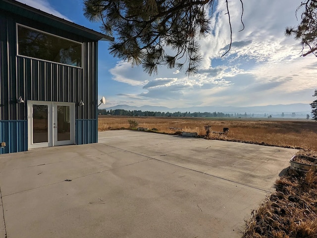 view of patio / terrace with french doors and a rural view