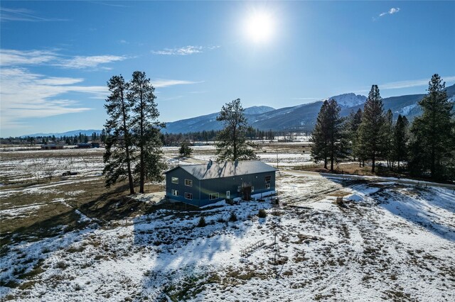 snowy aerial view featuring a mountain view