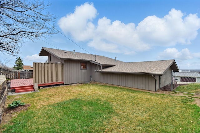 325 28th Ave NW, Great Falls, MT 59404 - back of house with fence, a wooden deck, a shingled roof, and a lawn