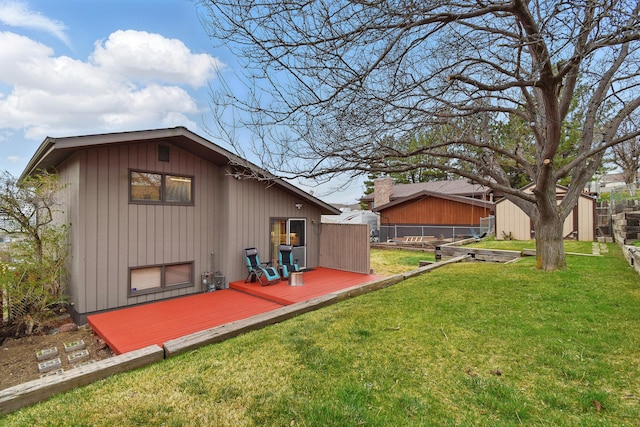 325 28th Ave NW, Great Falls, MT 59404 - back of property featuring a lawn, fence, an outbuilding, and a deck