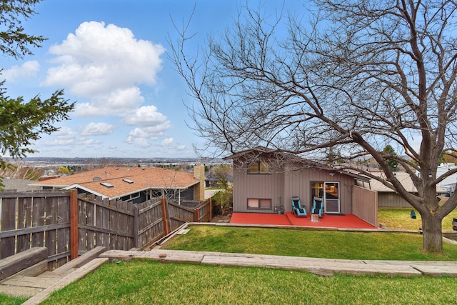 325 28th Ave NW, Great Falls, MT 59404 - back of property with fence, a lawn, and a deck