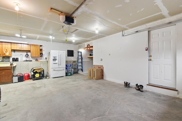 325 28th Ave NW, Great Falls, MT 59404 - garage with a garage door opener and white refrigerator with ice dispenser