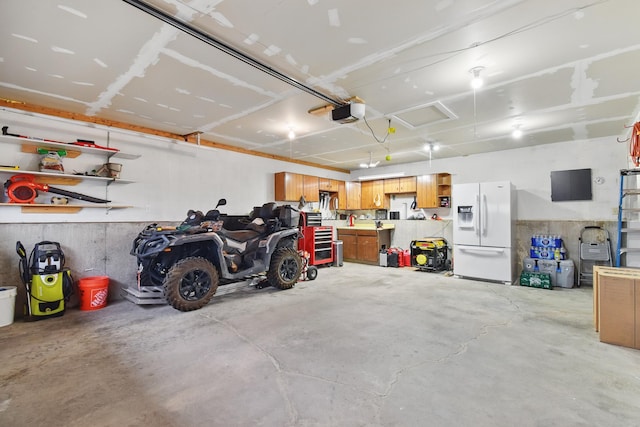 325 28th Ave NW, Great Falls, MT 59404 - garage with a garage door opener and white fridge with ice dispenser