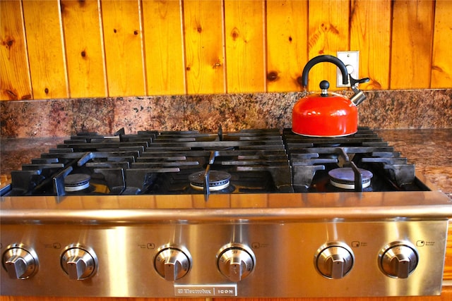 room details featuring stove and brown cabinets