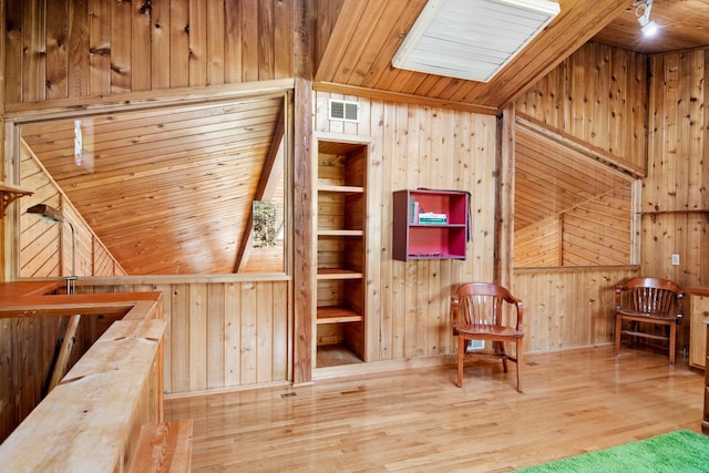 437 Tie Chute Ln, Florence, MT 59833 - sitting room with wooden walls, an upstairs landing, wood finished floors, a skylight, and wood ceiling