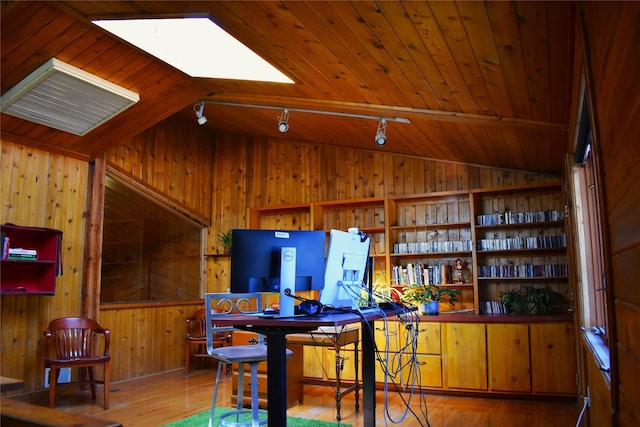 bar with wooden walls, wood finished floors, visible vents, wood ceiling, and lofted ceiling with skylight