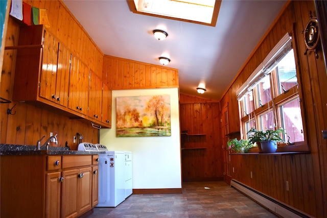 kitchen featuring vaulted ceiling, wood walls, a baseboard radiator, and brown cabinetry