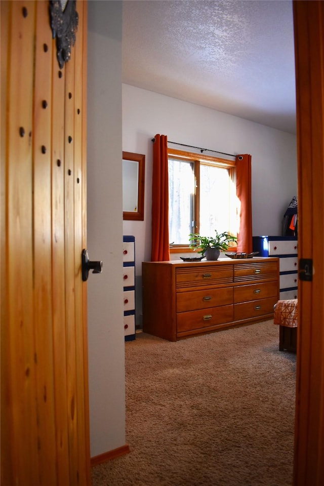 bedroom with a textured ceiling and carpet