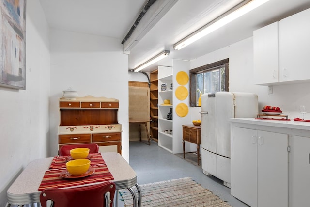 437 Tie Chute Ln, Florence, MT 59833 - kitchen featuring concrete floors, white cabinetry, and light countertops